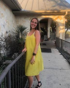 A person in a yellow dress

Description automatically generated
