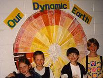 Photograph of students in front of Earth interior model.
