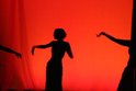The Mirage dancers silhouetted against a red background.